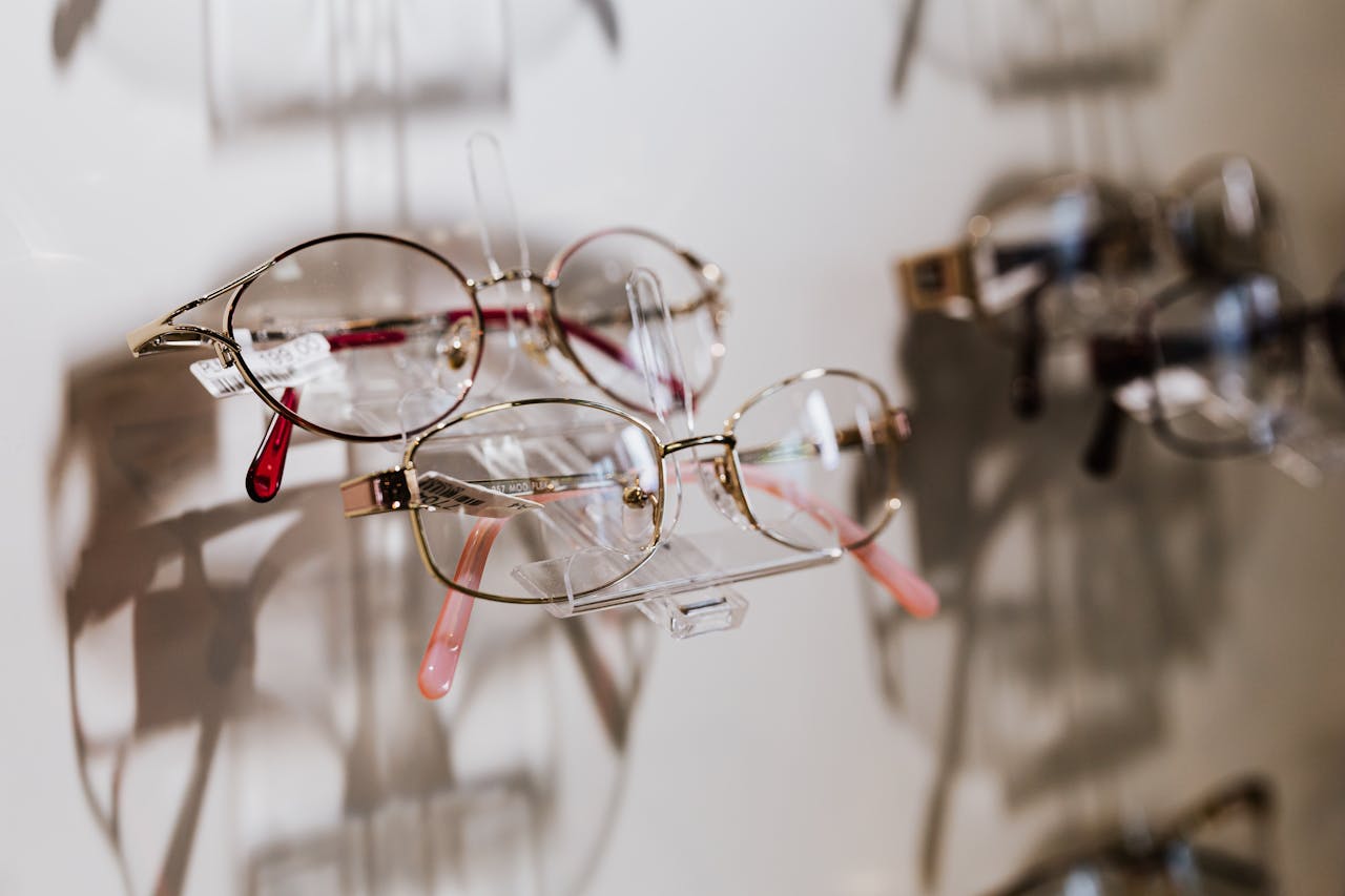 A close-up of stylish eyewear on display highlighting reflections and shadows.